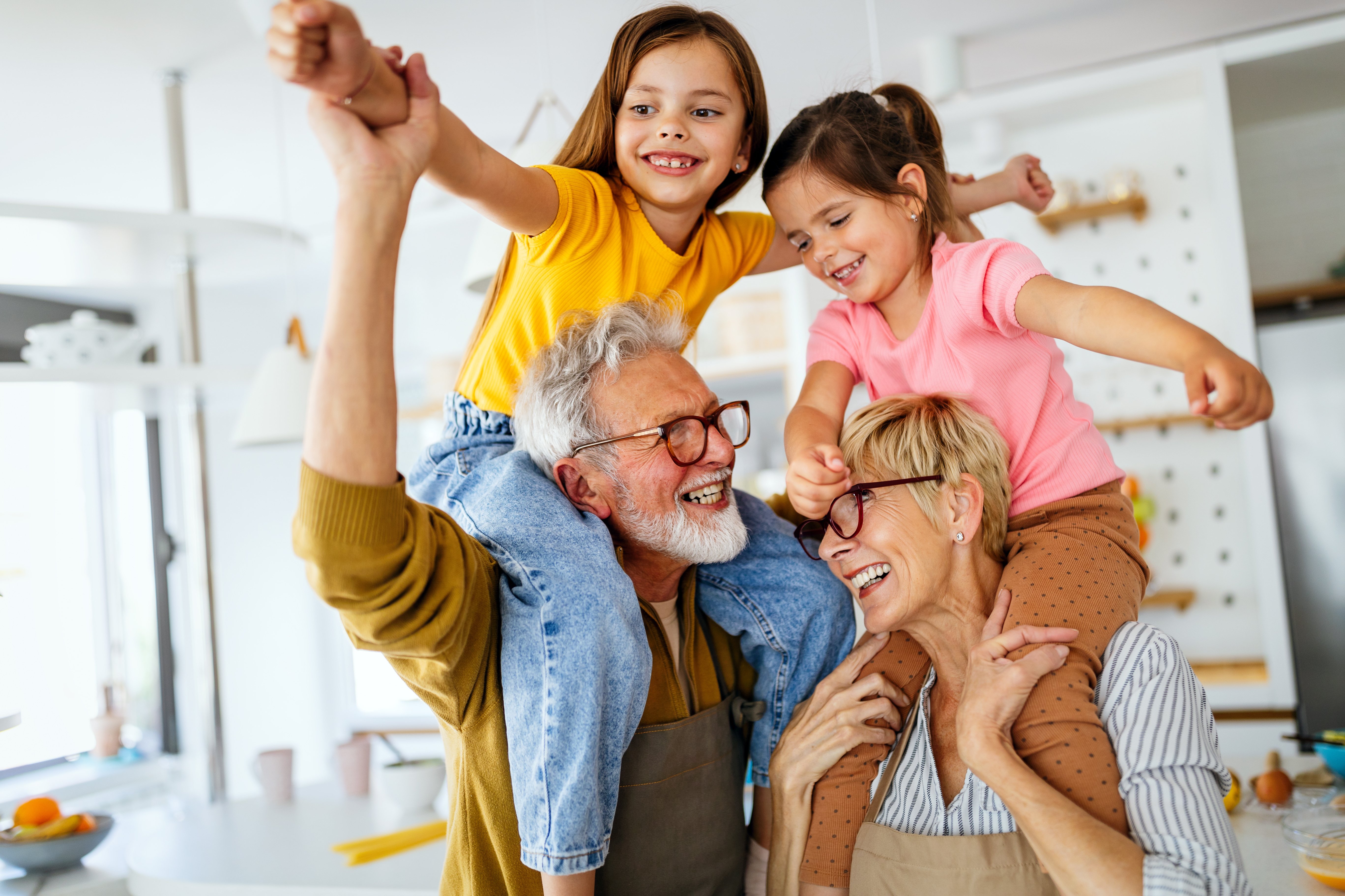 Happy grandparents playing with their grandchildren