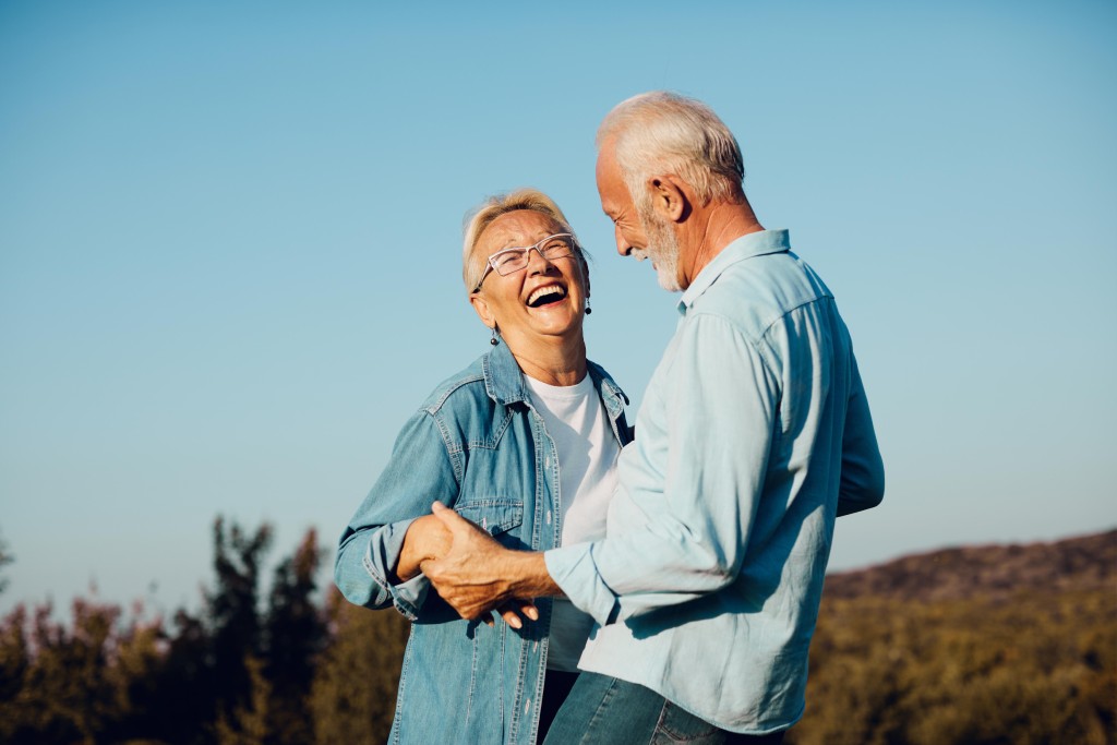 Elderly couple dancing outside