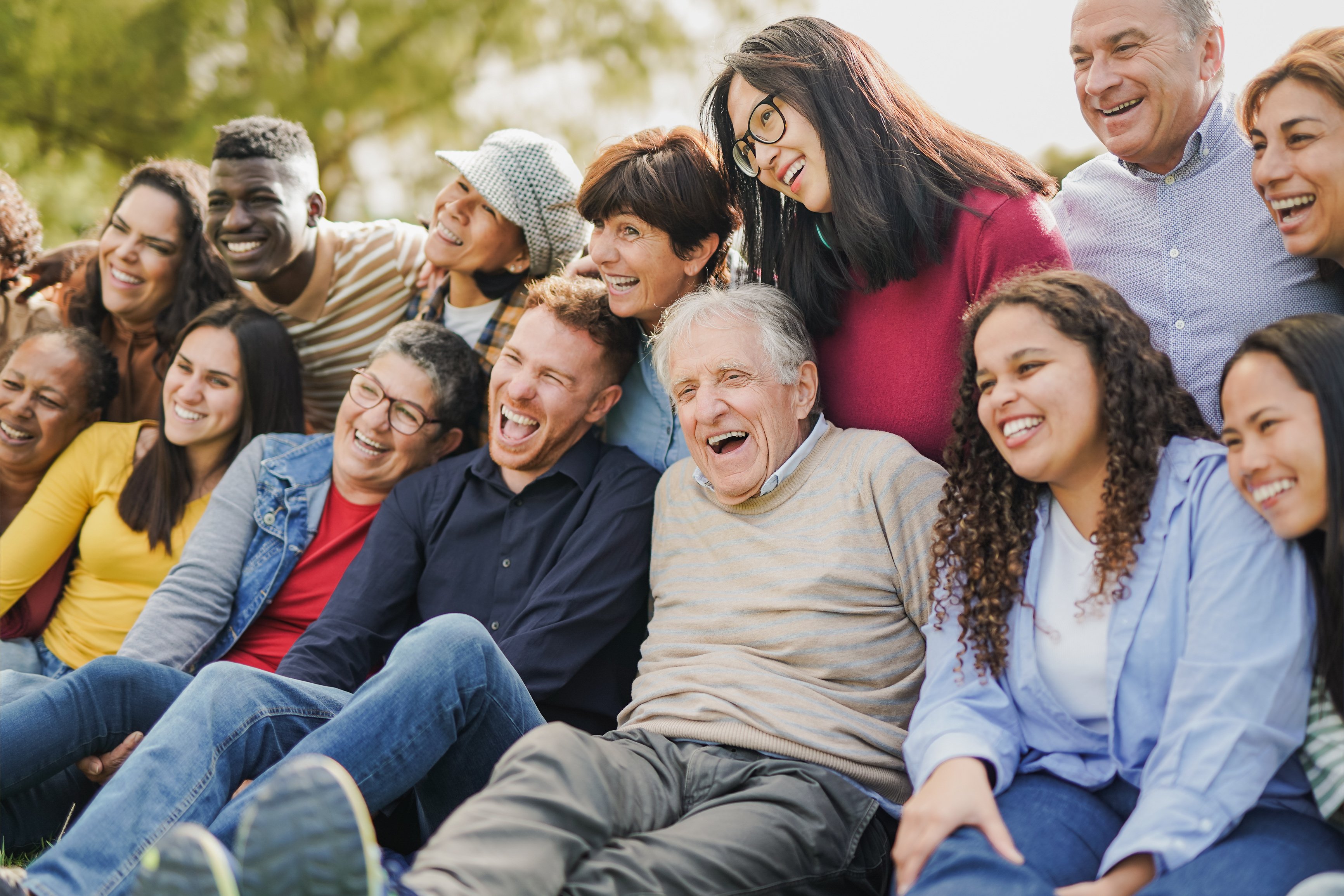 Diverse crowd of people having fun together at a park