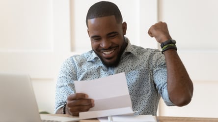 Happy Man reviewing his tax return documents