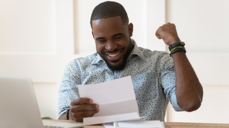 Happy Man reviewing his tax return documents