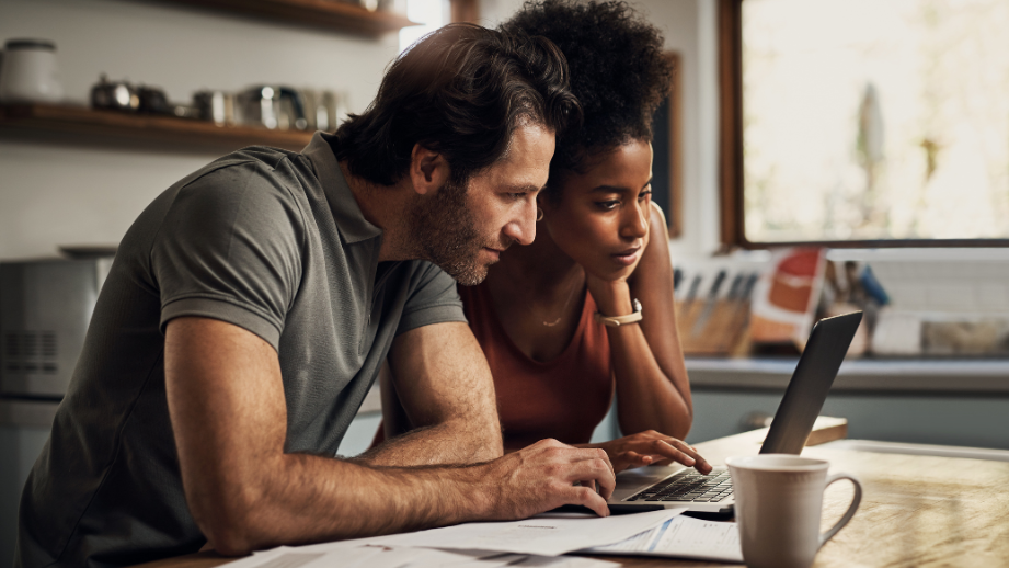 A couple looking at a computer screen while reviewing homeownership prequalification information.