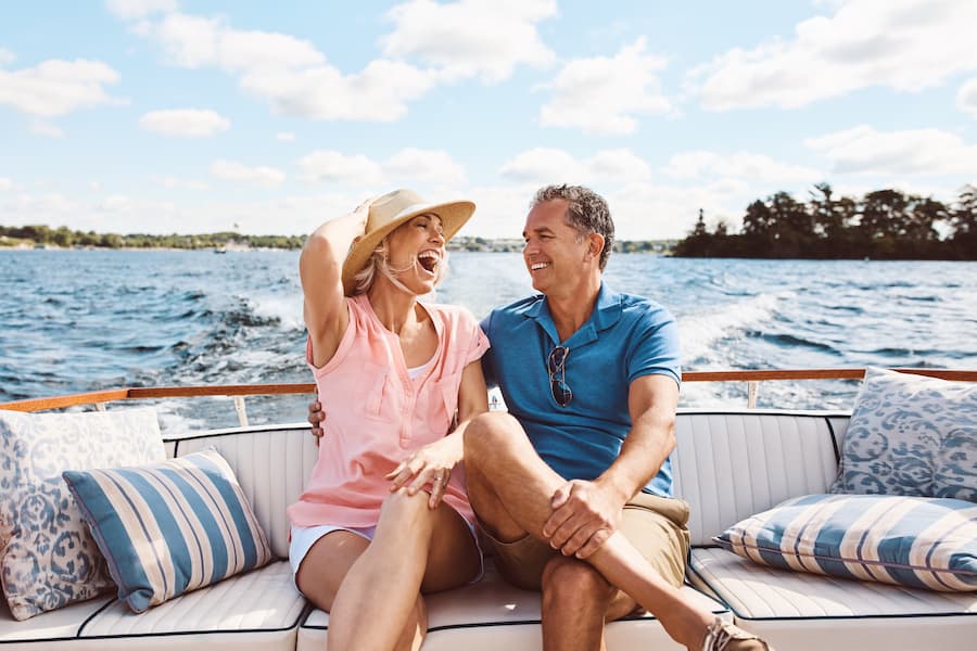 Happy couple sitting on their boat