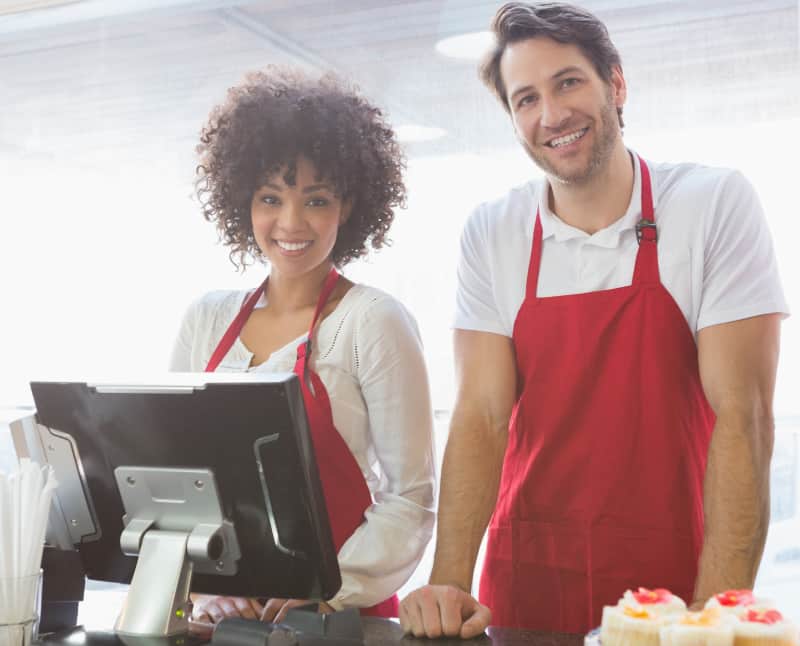 Business partners working together in a restaurant, happy to serve the next customers.