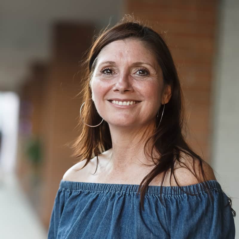 Smiling and Happy middle-aged woman, 50+. She is confidently ready to secure a brighter financial future.