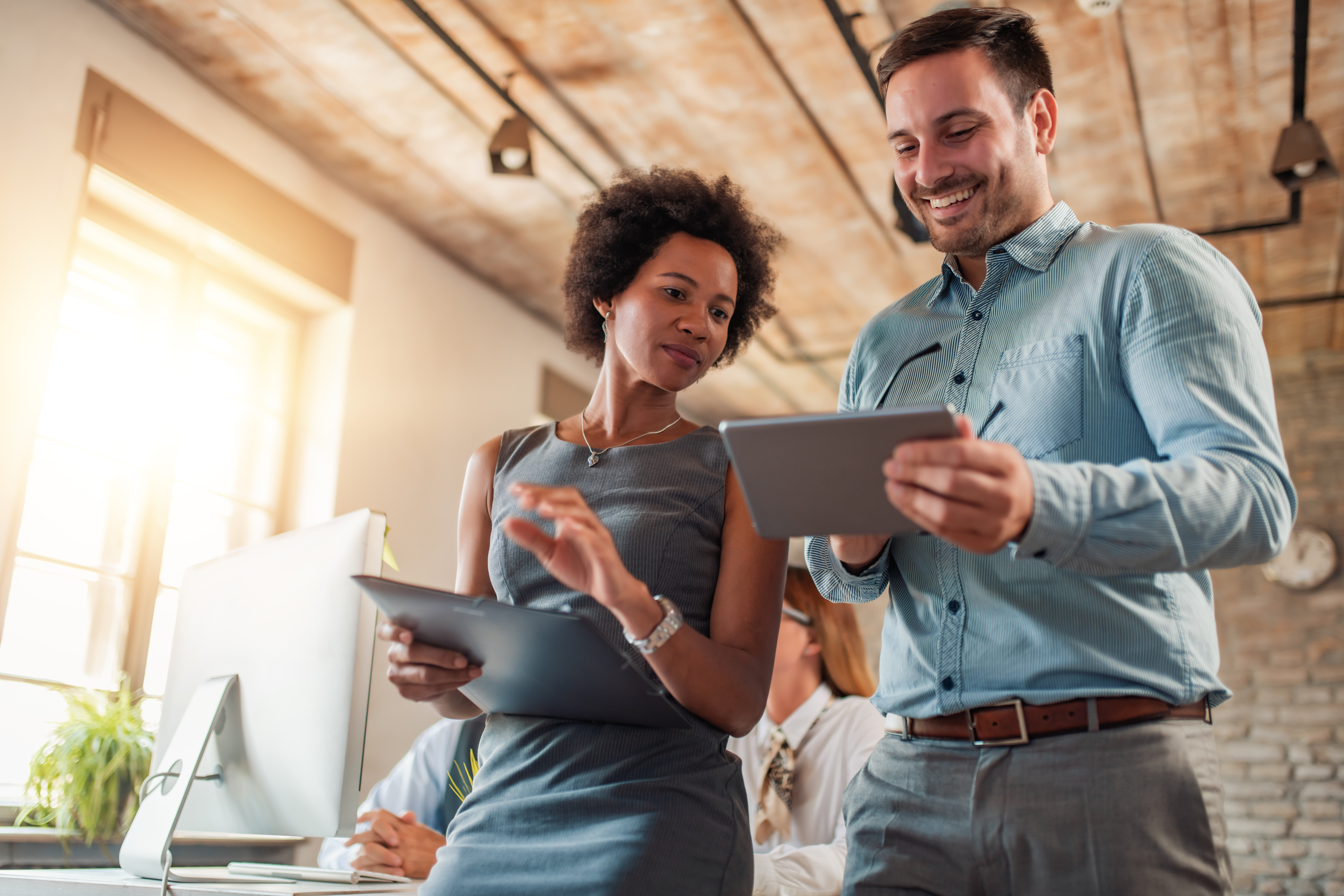 A man and woman discuss applying for a business loan to expand their operations.